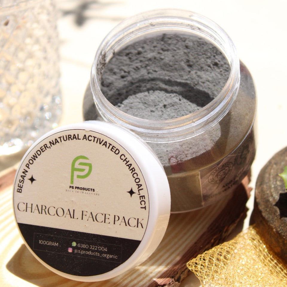 Jar of charcoal face pack with a label on a textured surface