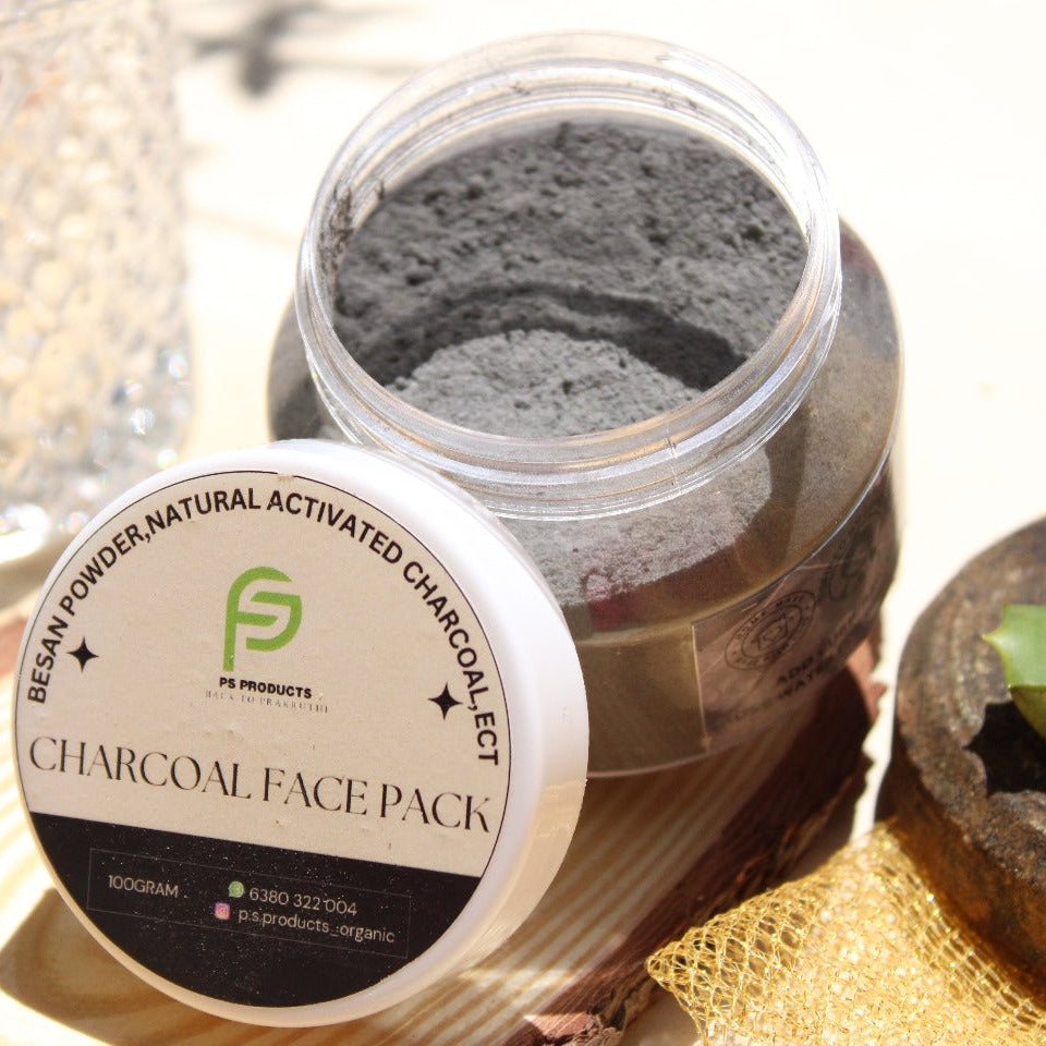 Jar of charcoal face pack with a label on a textured surface