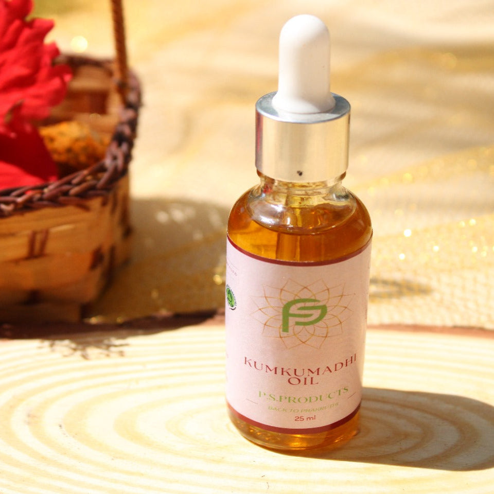 Bottle of Kumkumadi oil with a dropper on a textured surface