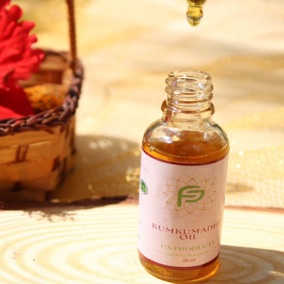 Bottle of Kumkumadi oil with a red flower and woven basket in the background