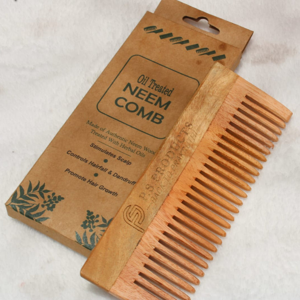 Wooden comb with packaging on a light background