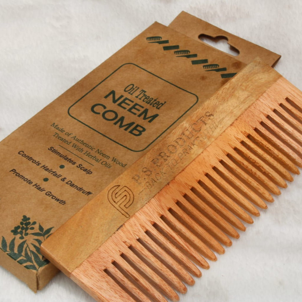 Neem comb with packaging on a light background